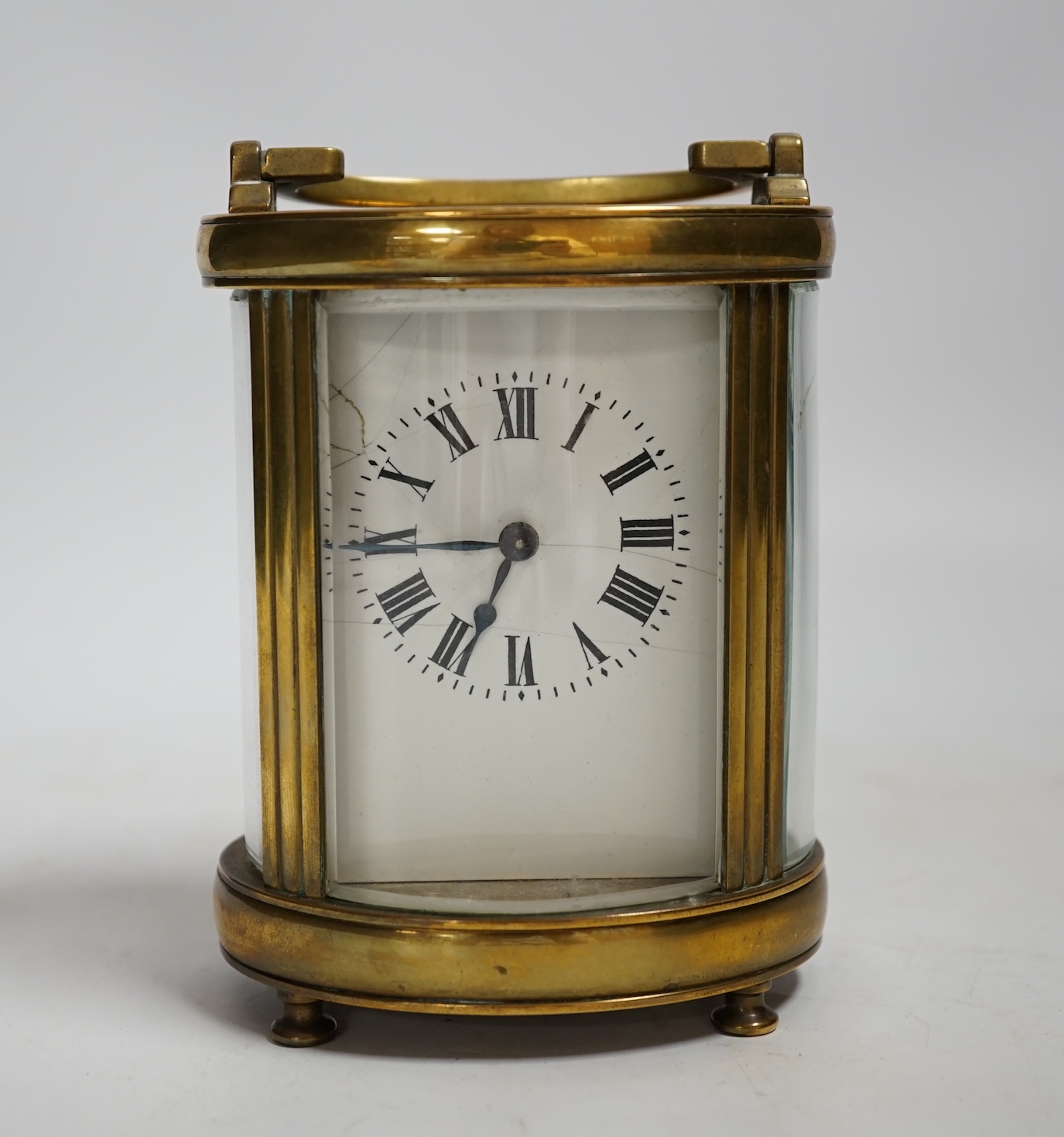 A brass oval cased carriage timepiece, stamped ‘Made in France’, 12cm